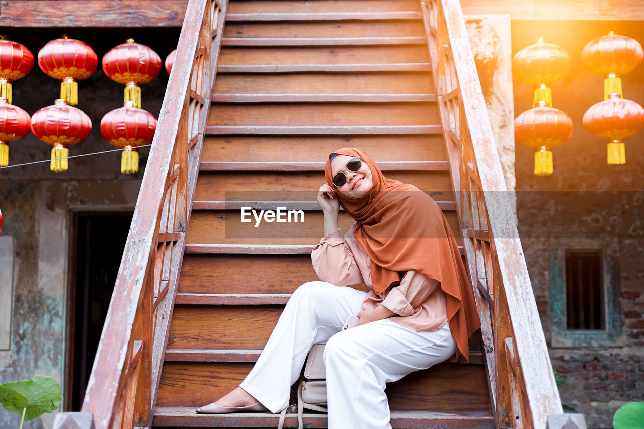 Woman sitting on staircase