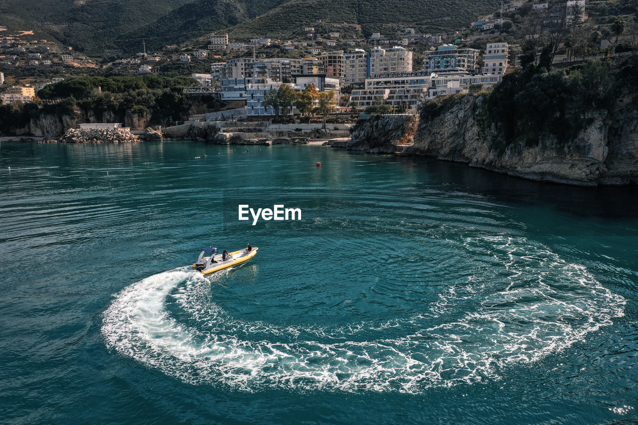 High angle view of sea and buildings in city