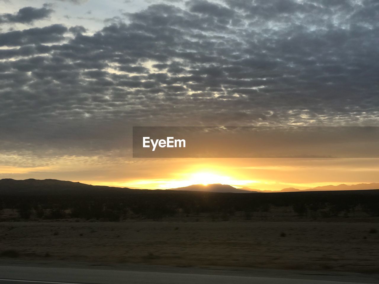 SCENIC VIEW OF SILHOUETTE LANDSCAPE AGAINST SUNSET SKY