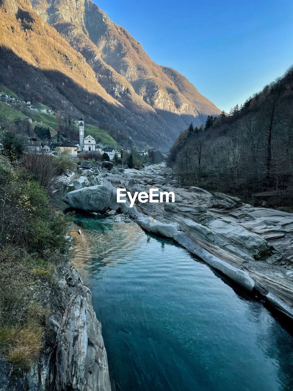 Scenic view of river amidst mountains against sky in lavertezzo