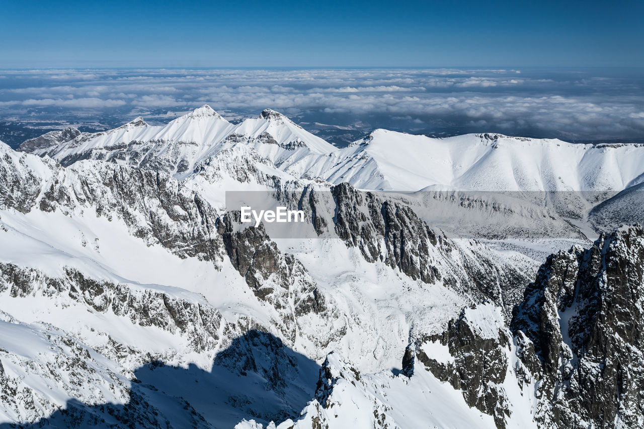 Scenic view of snowcapped mountains against sky during winter. 