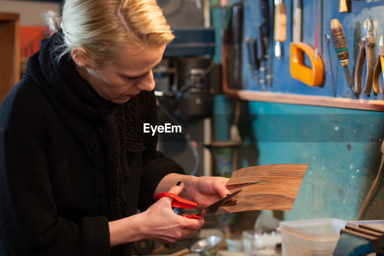 Mature woman working at carpentry workshop