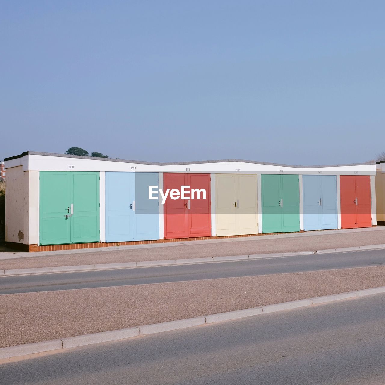 MULTI COLORED BUILDING AGAINST CLEAR BLUE SKY