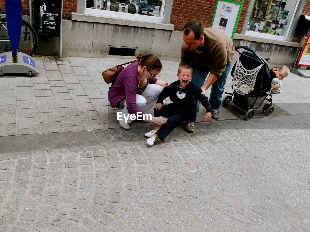 FULL LENGTH OF FATHER AND SON ON SIDEWALK