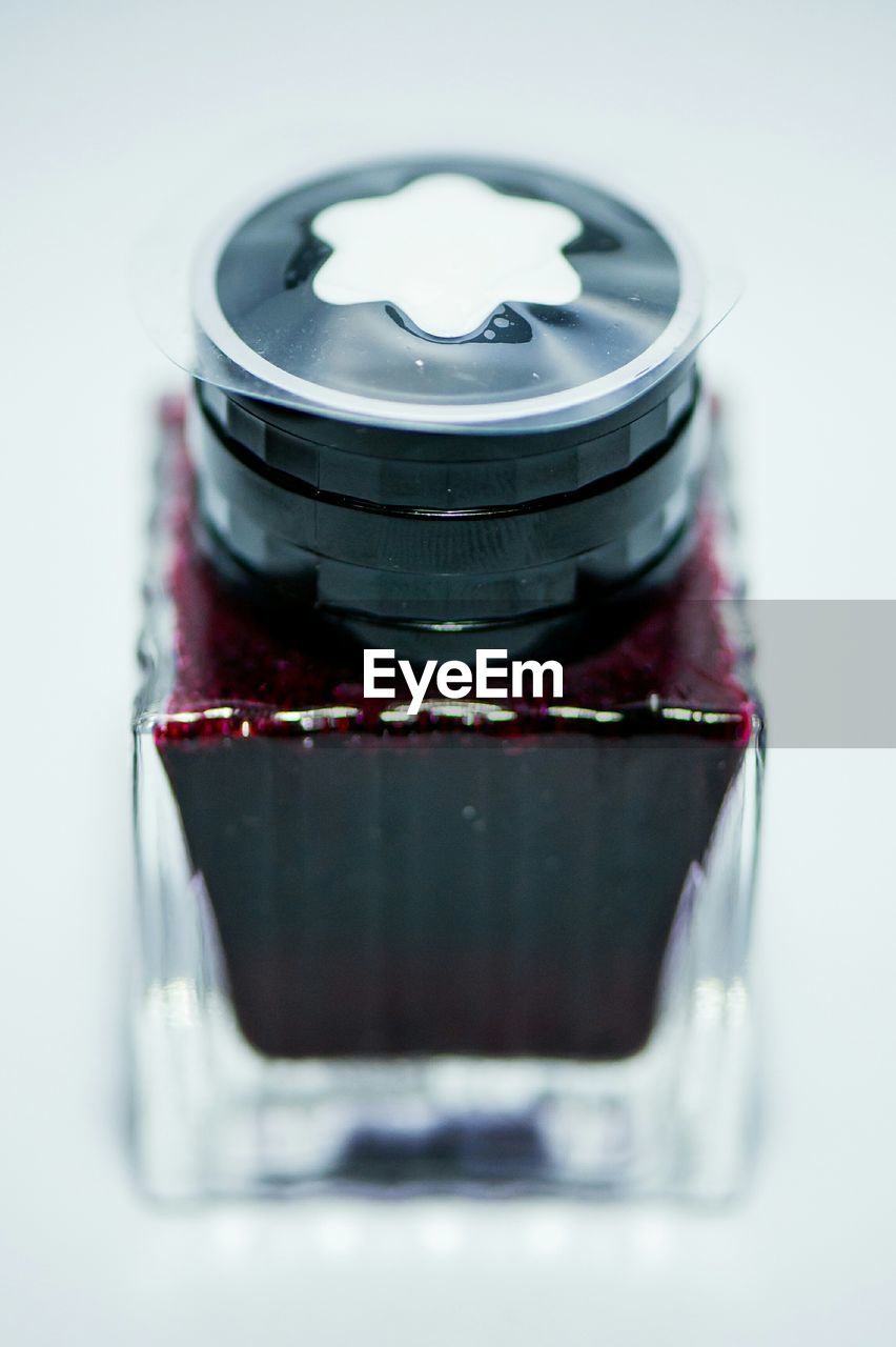 High angle view of nail polish bottle against white background