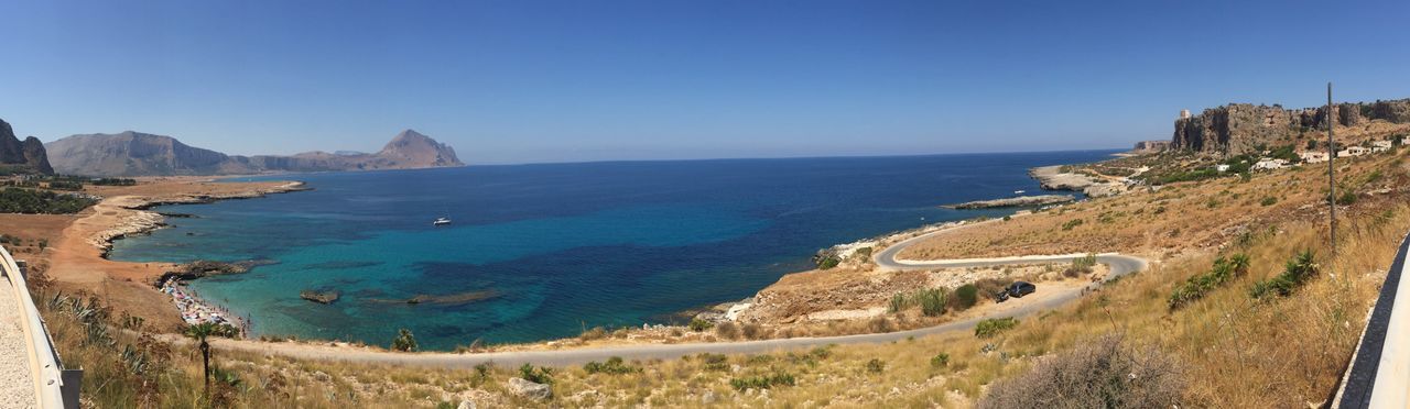 PANORAMIC VIEW OF BEACH AGAINST CLEAR BLUE SKY