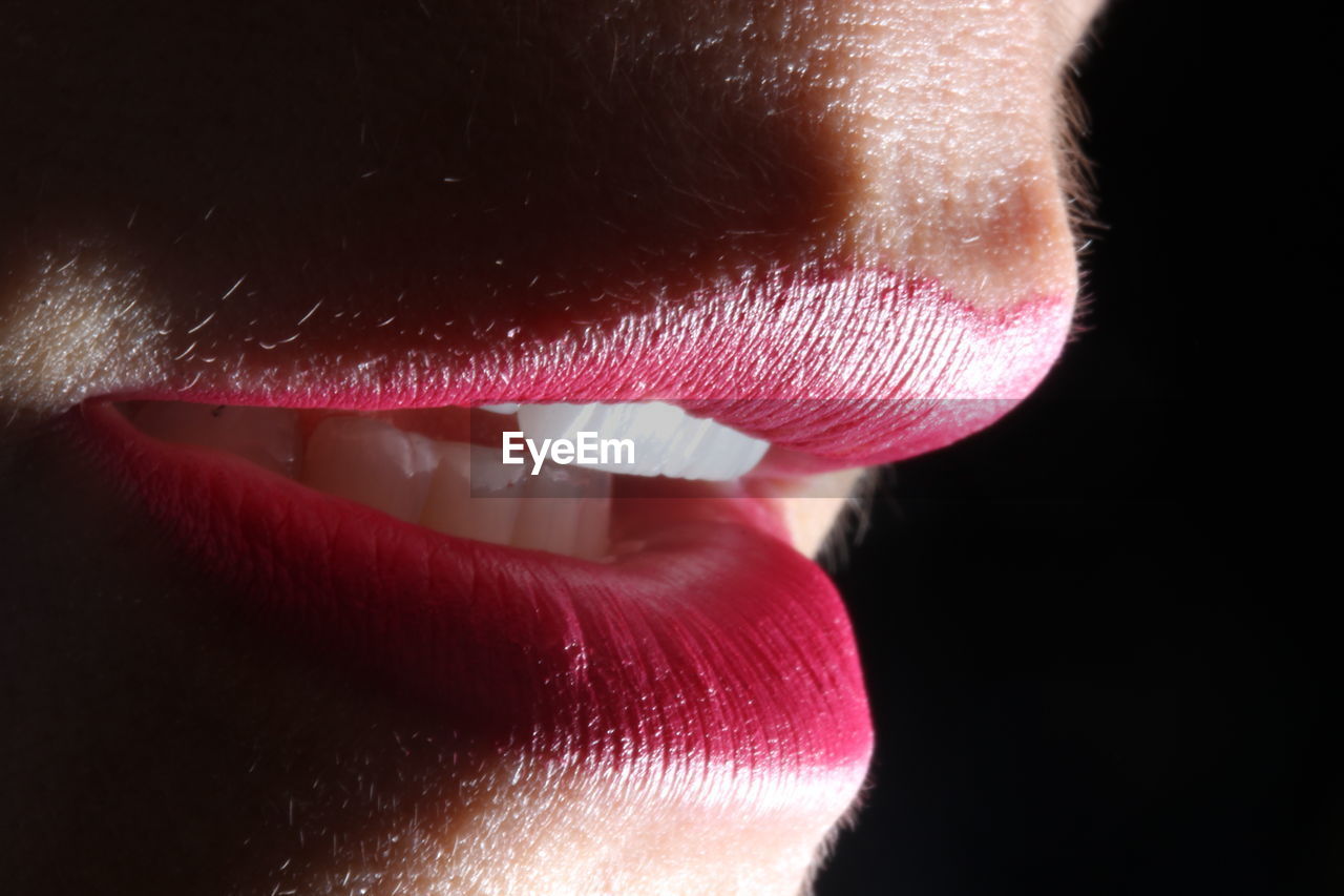 Extreme close up of woman with pink lips