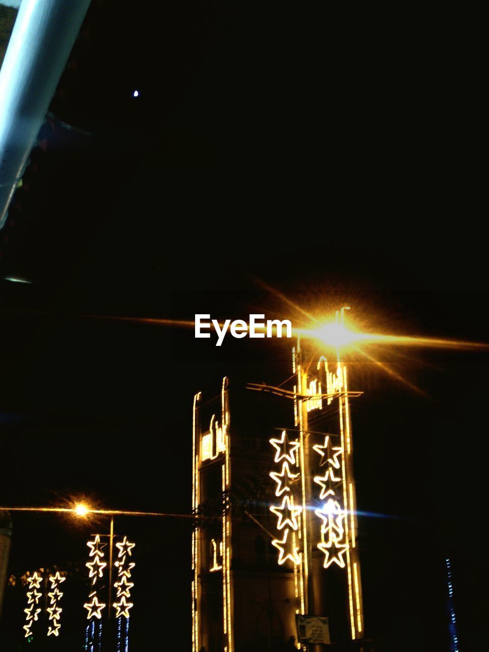 LOW ANGLE VIEW OF ILLUMINATED LIGHTS AGAINST SKY