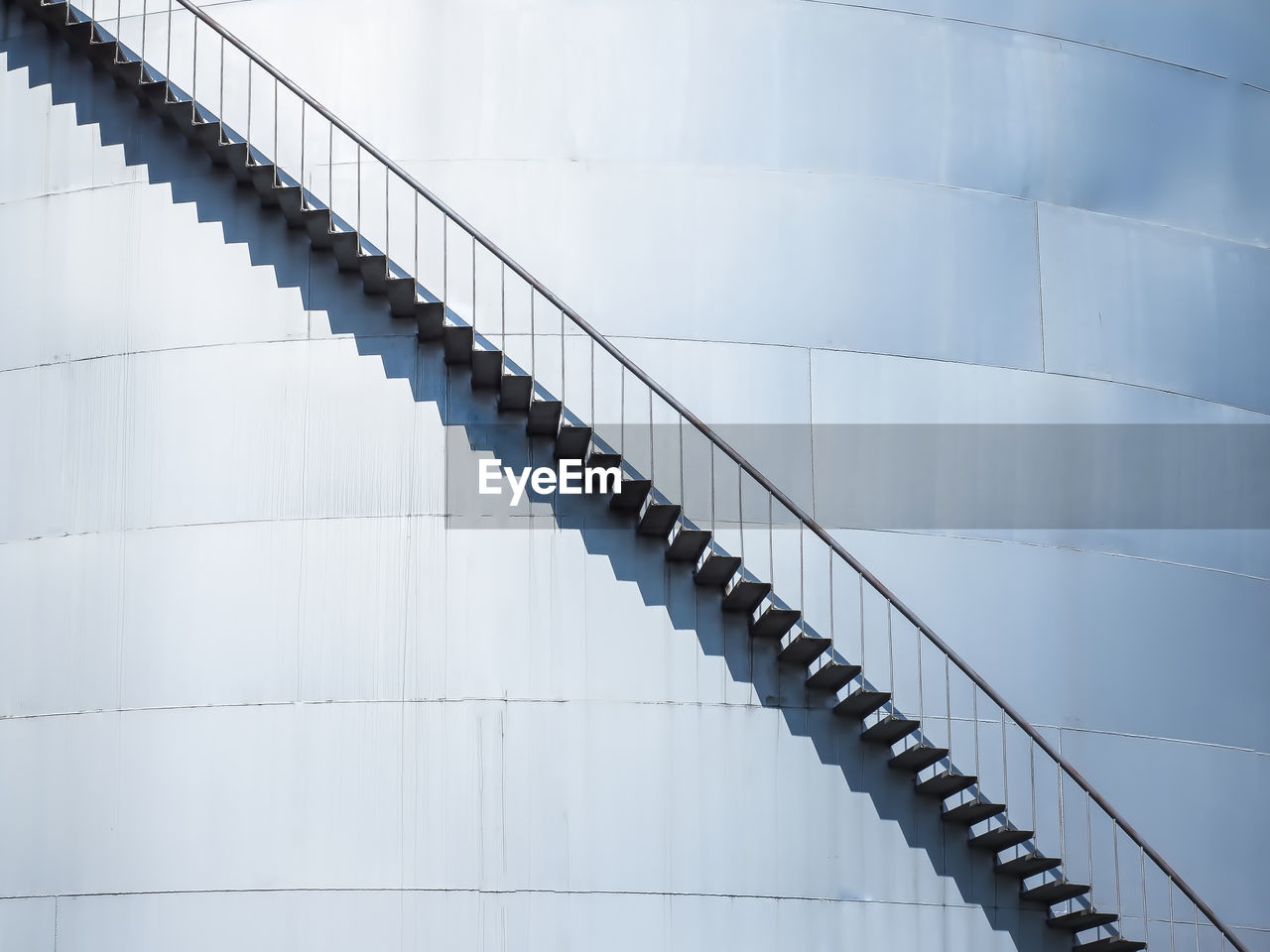 Low angle view of staircase on storage tank