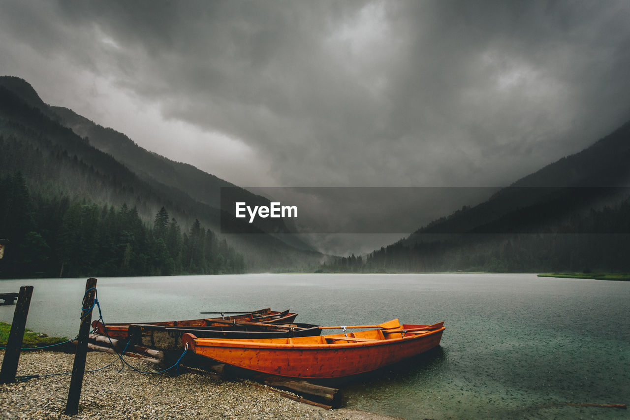 Boats in lake against mountains