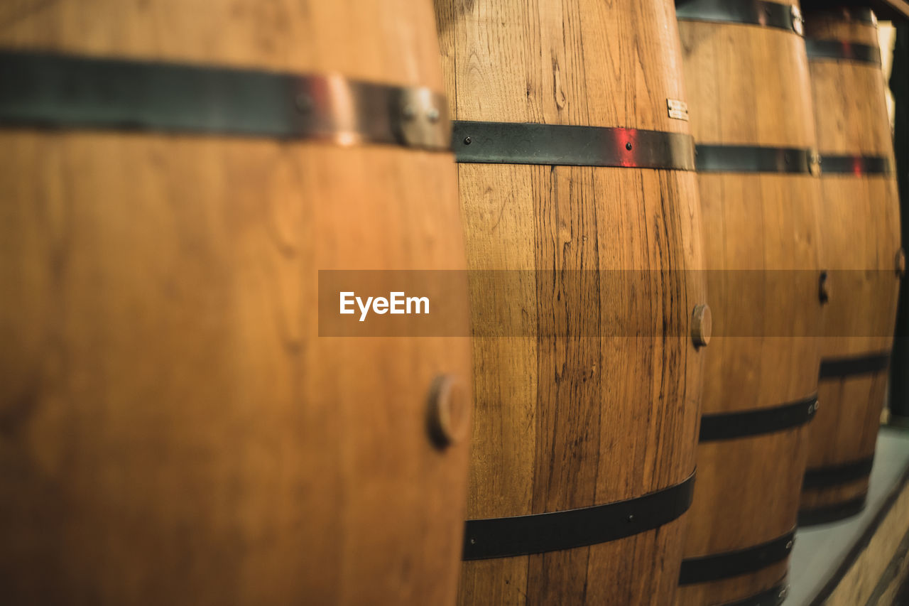 Close-up of wooden barrels at winery