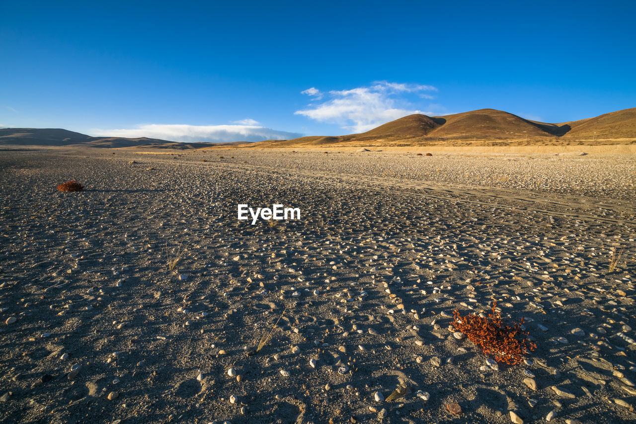 Scenic view of arid landscape against sky