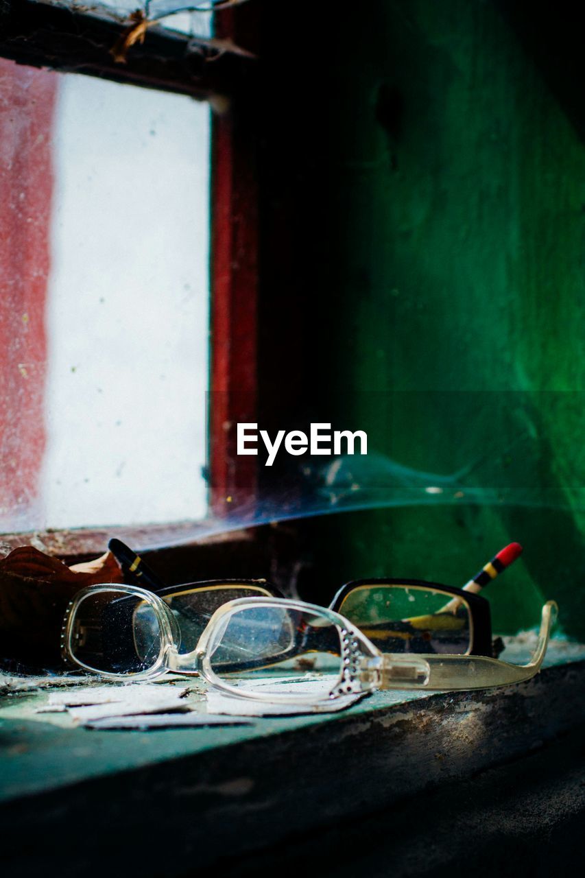 Pair of abandoned eyeglasses on window sill