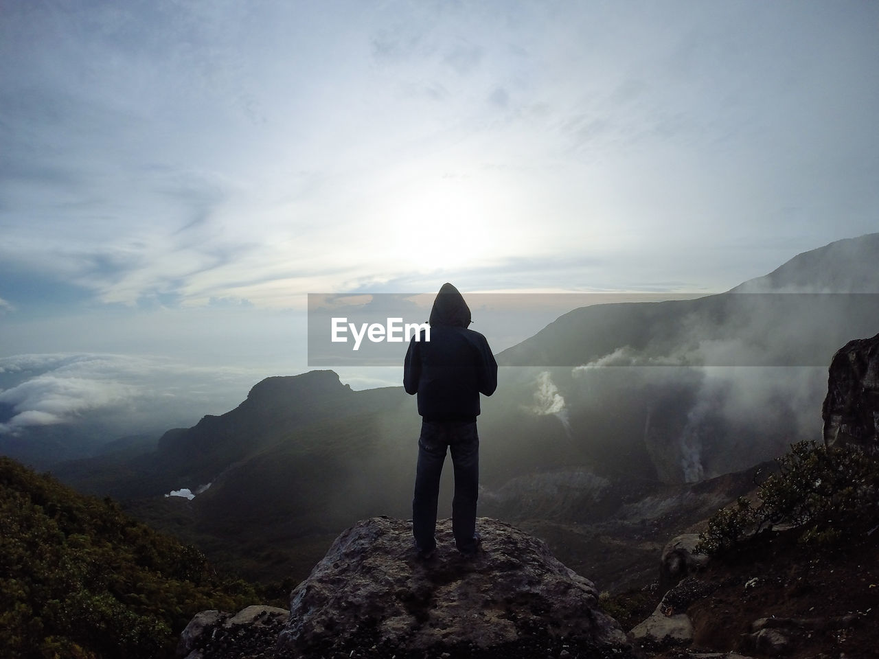 Full length rear view of man standing on top of mountain