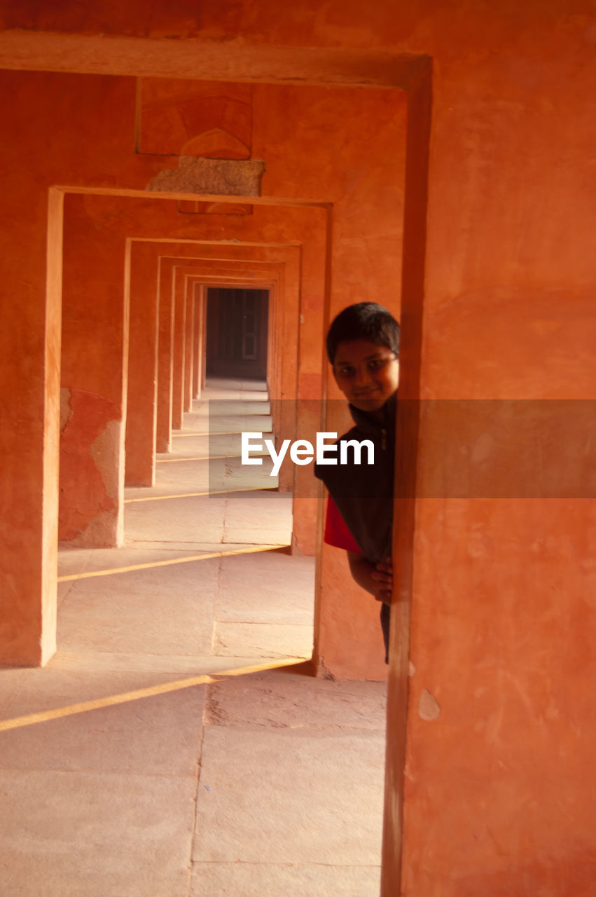 Portrait of boy standing in corridor