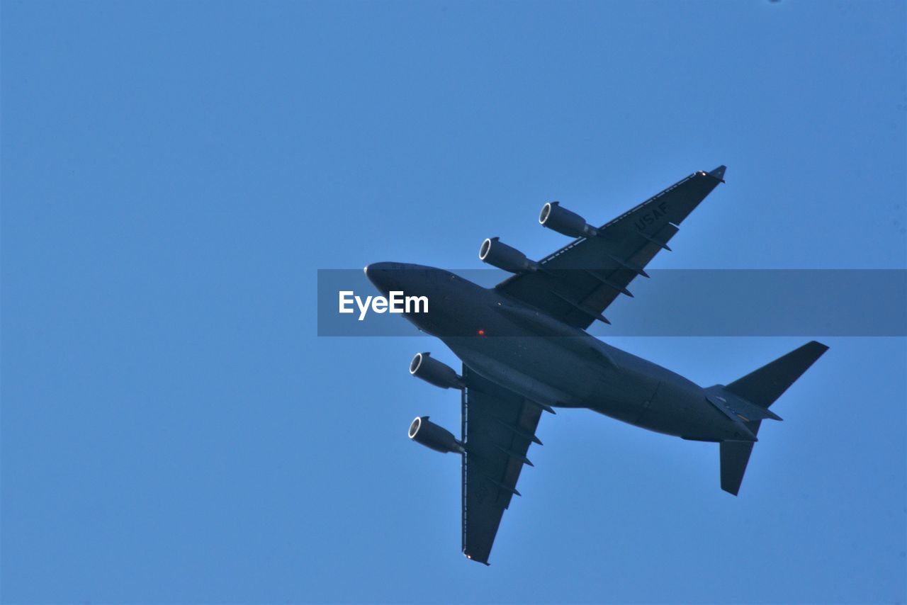 Low angle view of airplane against clear sky