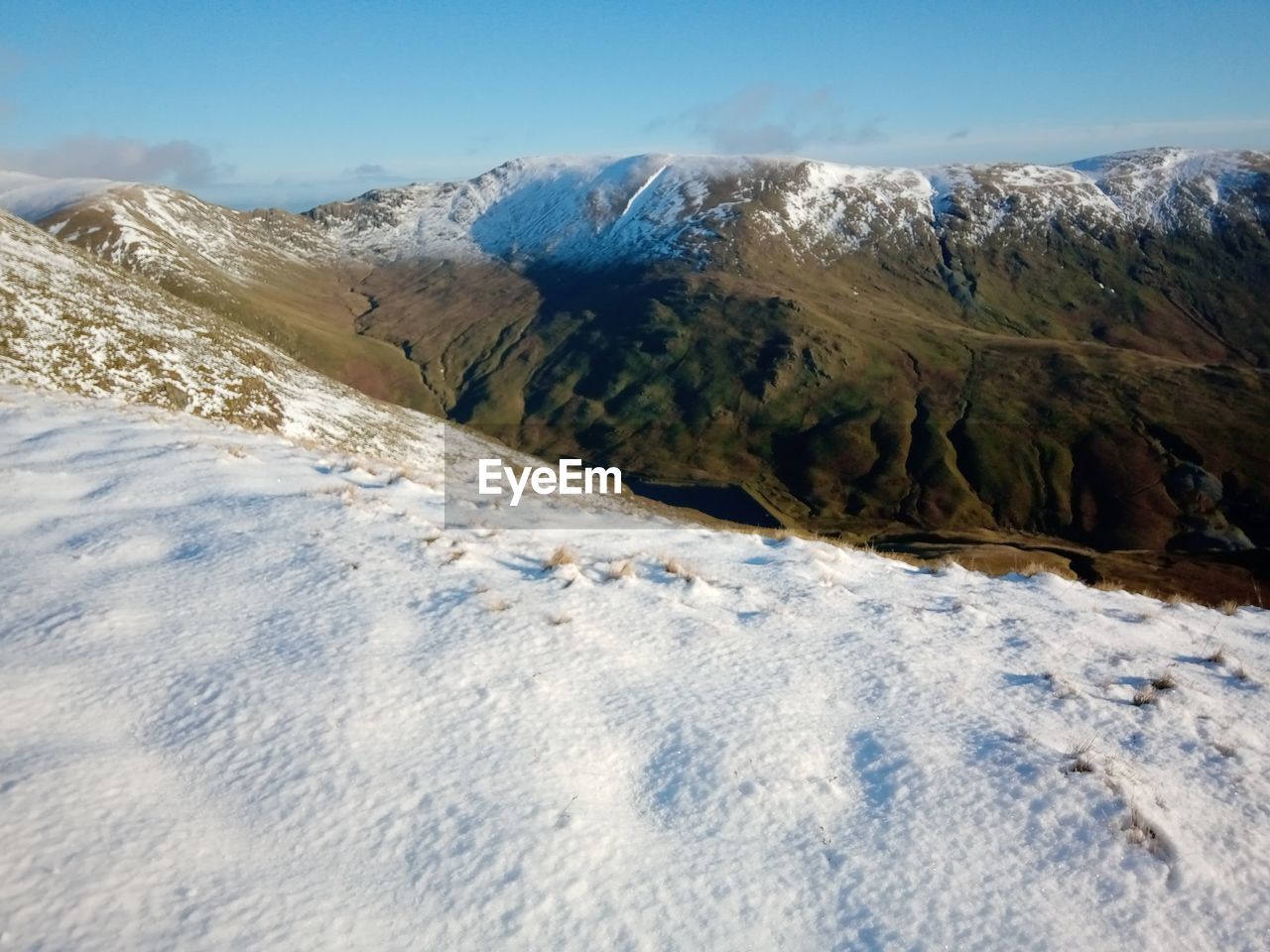 Panoramic view over a snow capped mountain ridge. 