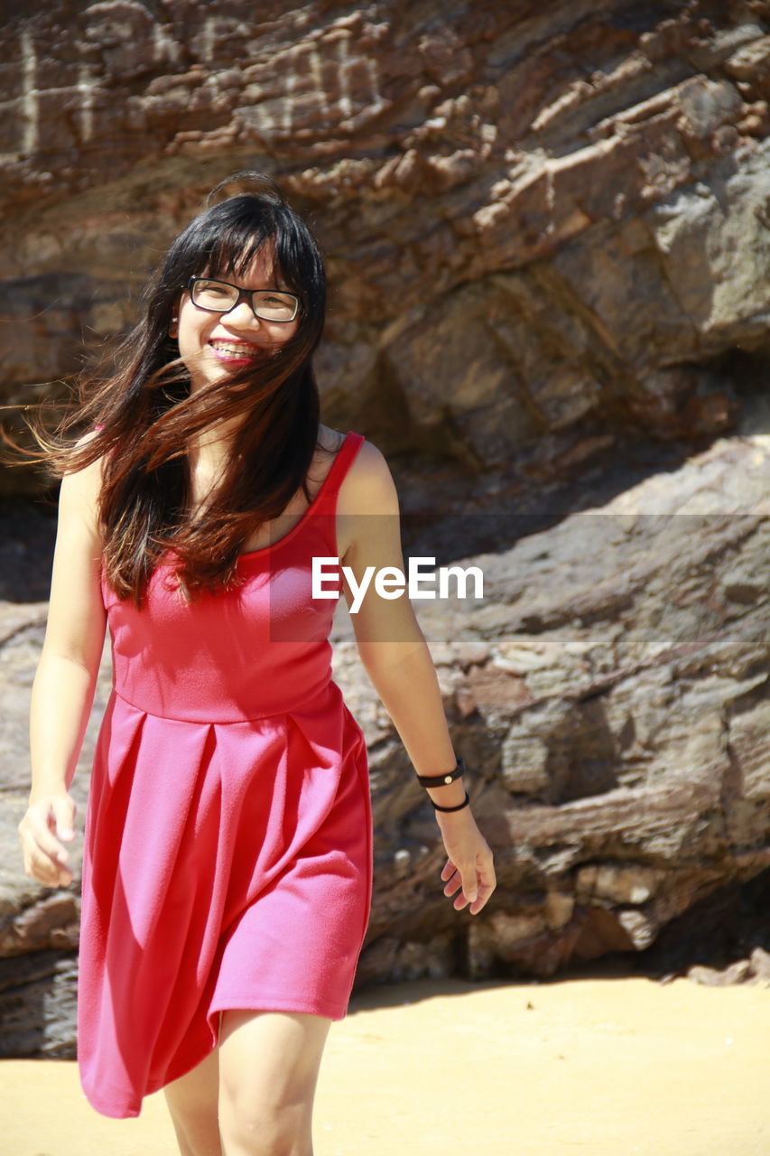 Woman wearing eyeglasses standing on beach