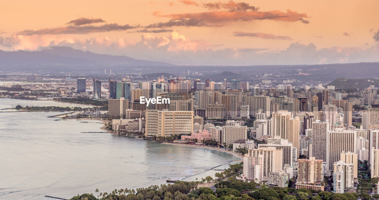HIGH ANGLE VIEW OF CITY BUILDINGS BY SEA
