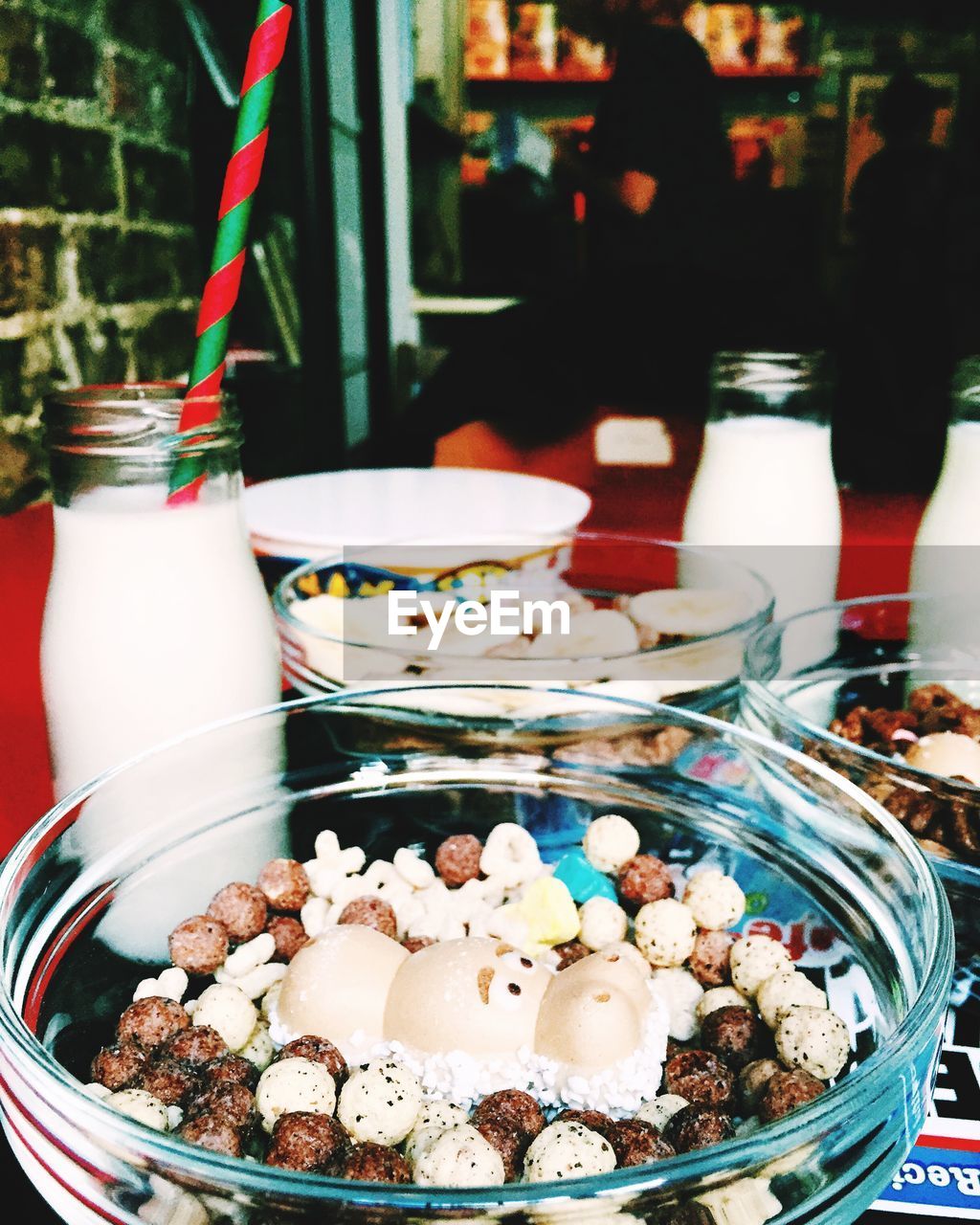 Close-up of fresh breakfast and milk bottles on table in restaurant