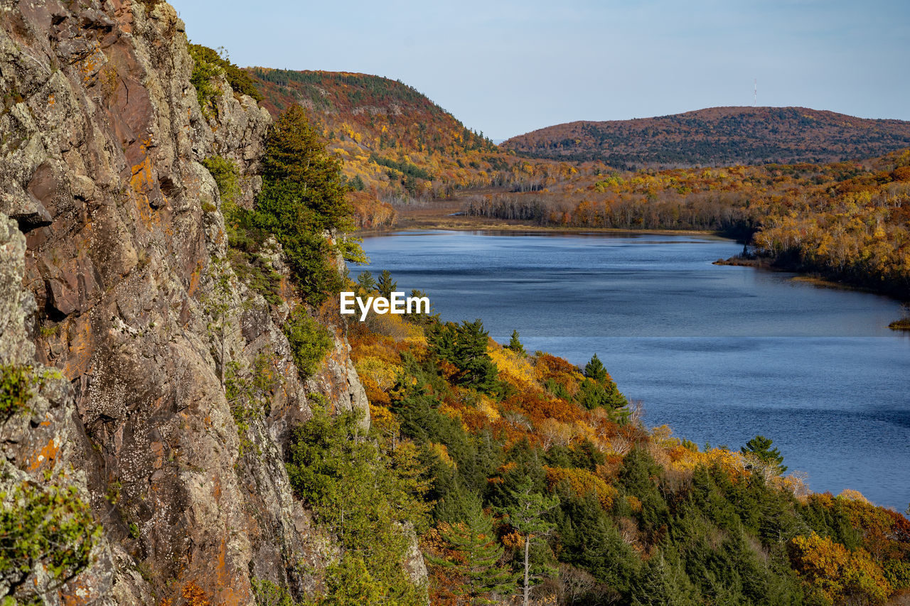 Scenic view of sea and mountains against sky