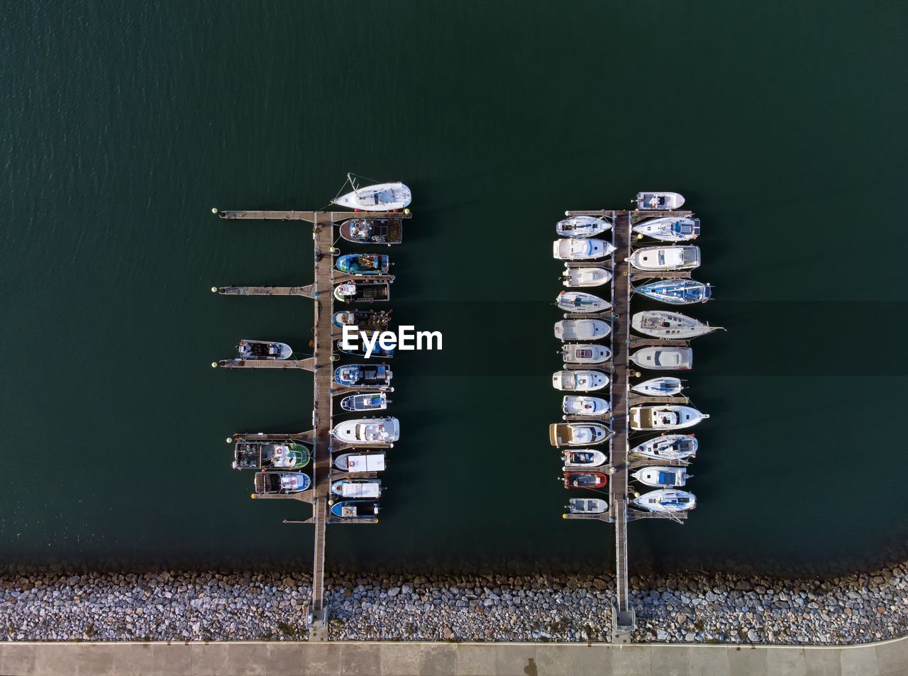 Panoramic aerial view on boats moored in the pier, drone shot directly above. luanco in asturias