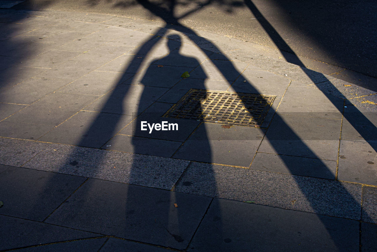 Shadow of man walking on street