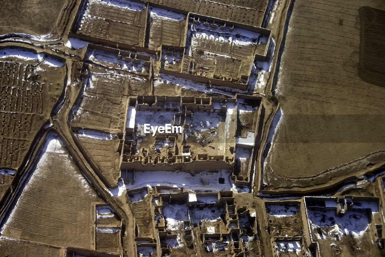 High angle view of wot-torn buildings cover with snow in winter