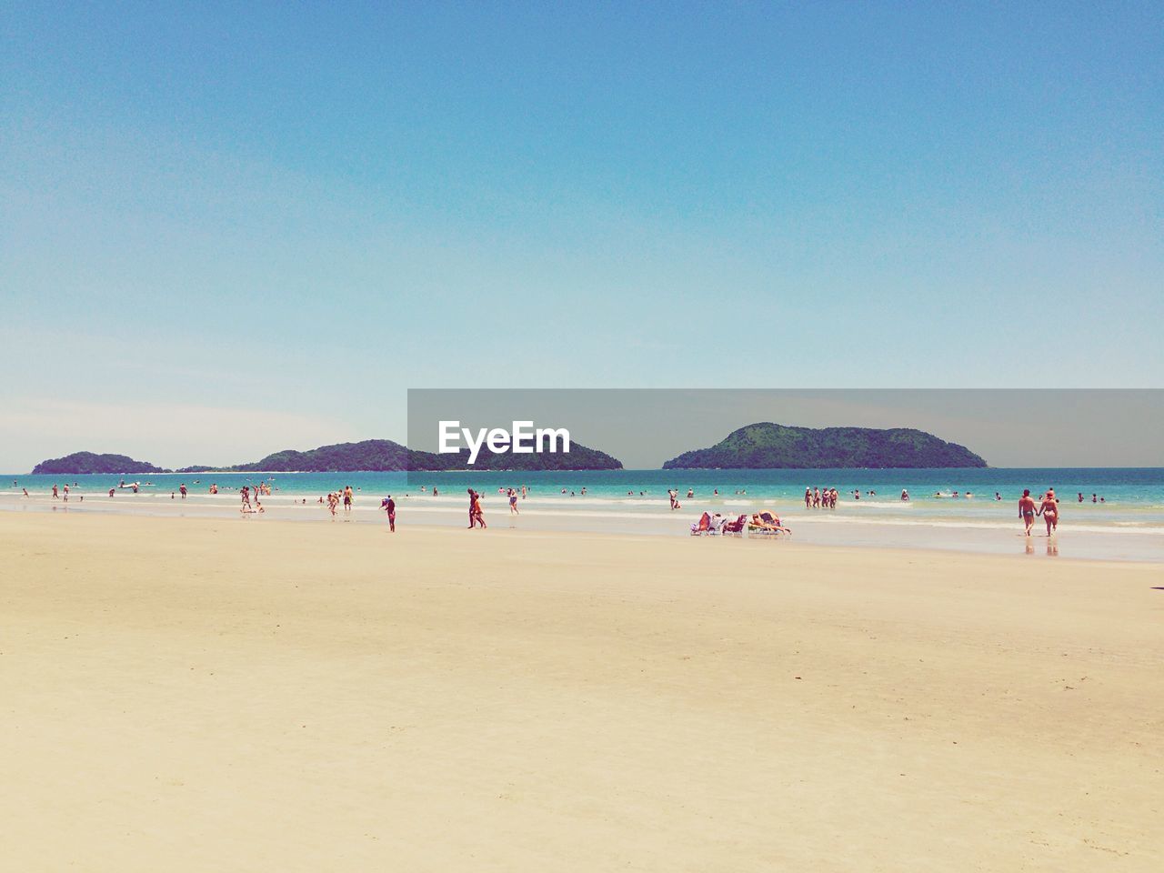 Distance shot of people on beach