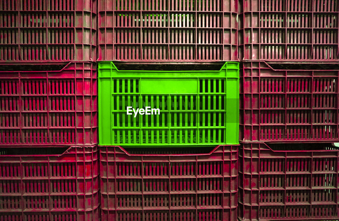 Green safe between plastic red crates.