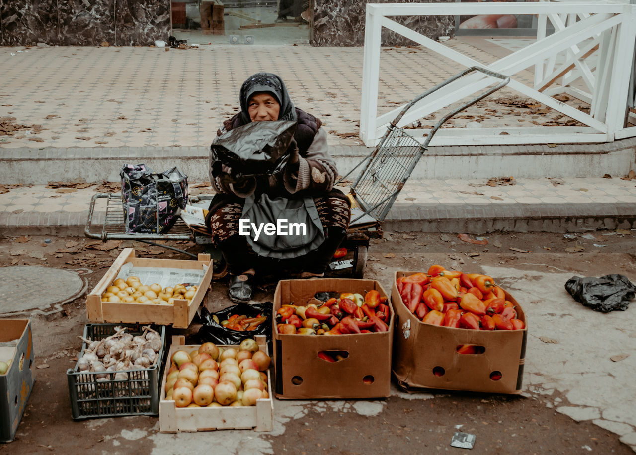 Woman selling fruits and vegetables at market stall