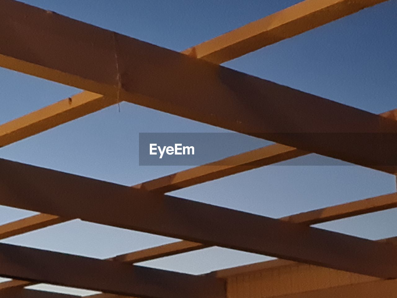 LOW ANGLE VIEW OF ROOF AGAINST BLUE SKY