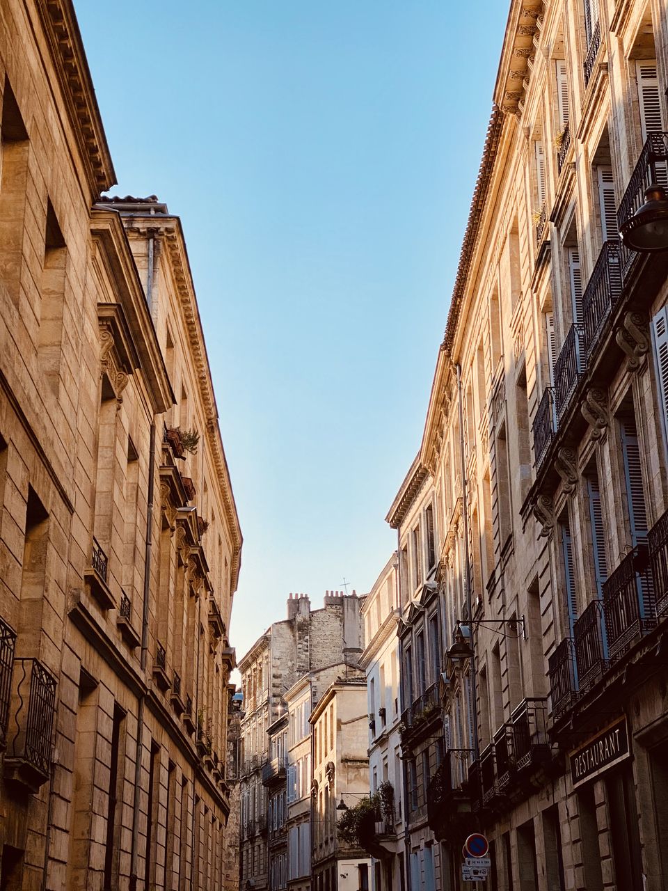 Low angle view of buildings against clear blue sky