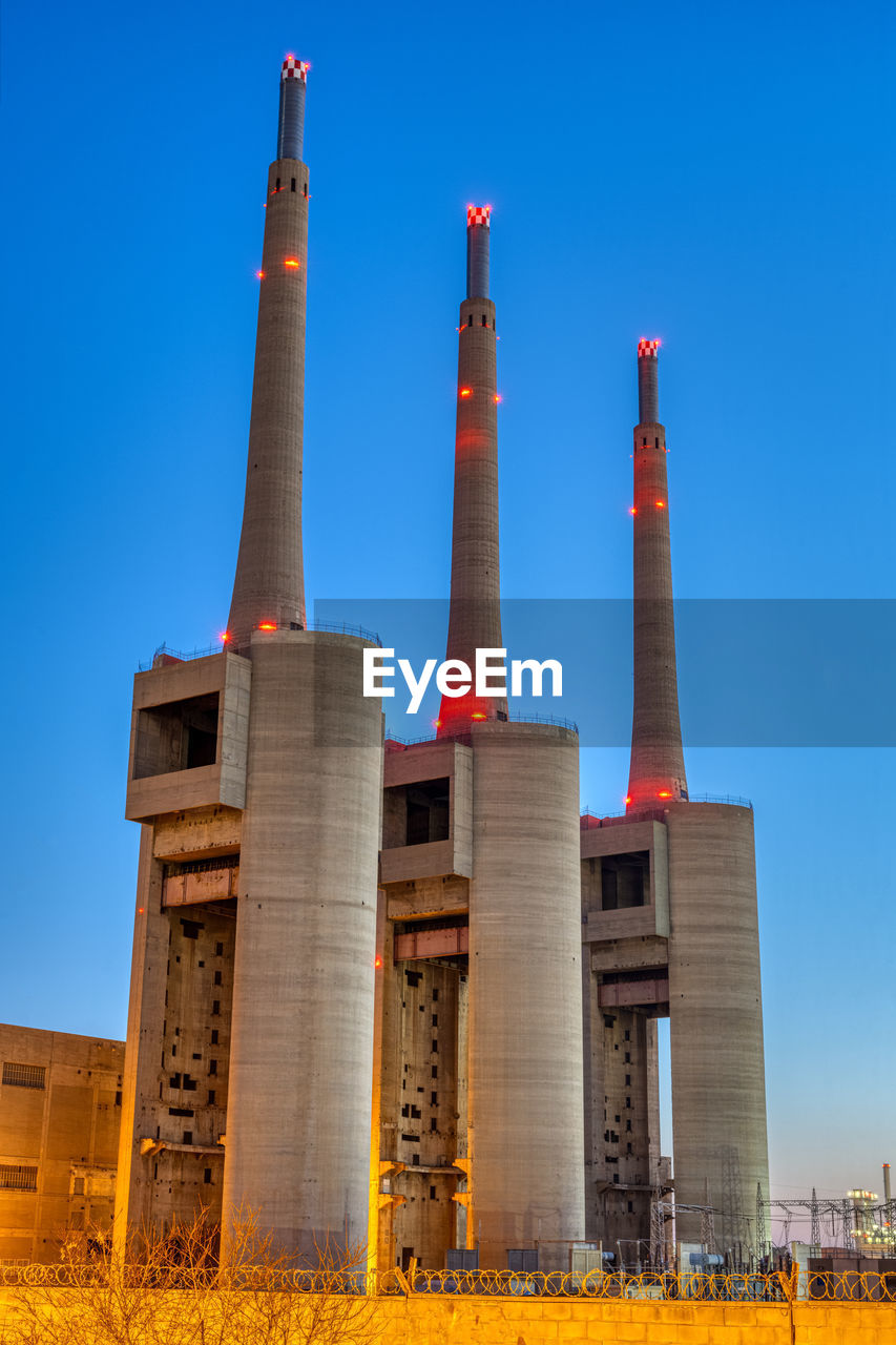 The disused thermal power station at sand adria near barcelona at dusk