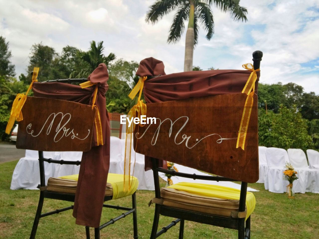 Lounge chairs on grass against sky