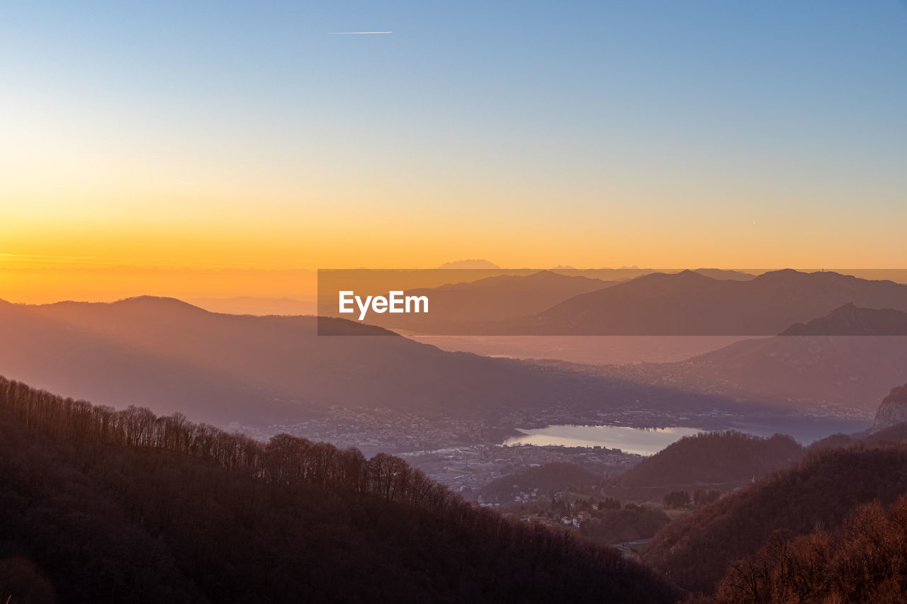 Scenic view of silhouette mountains against sky during sunset