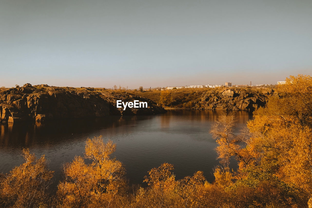 Scenic view of lake against clear sky during autumn