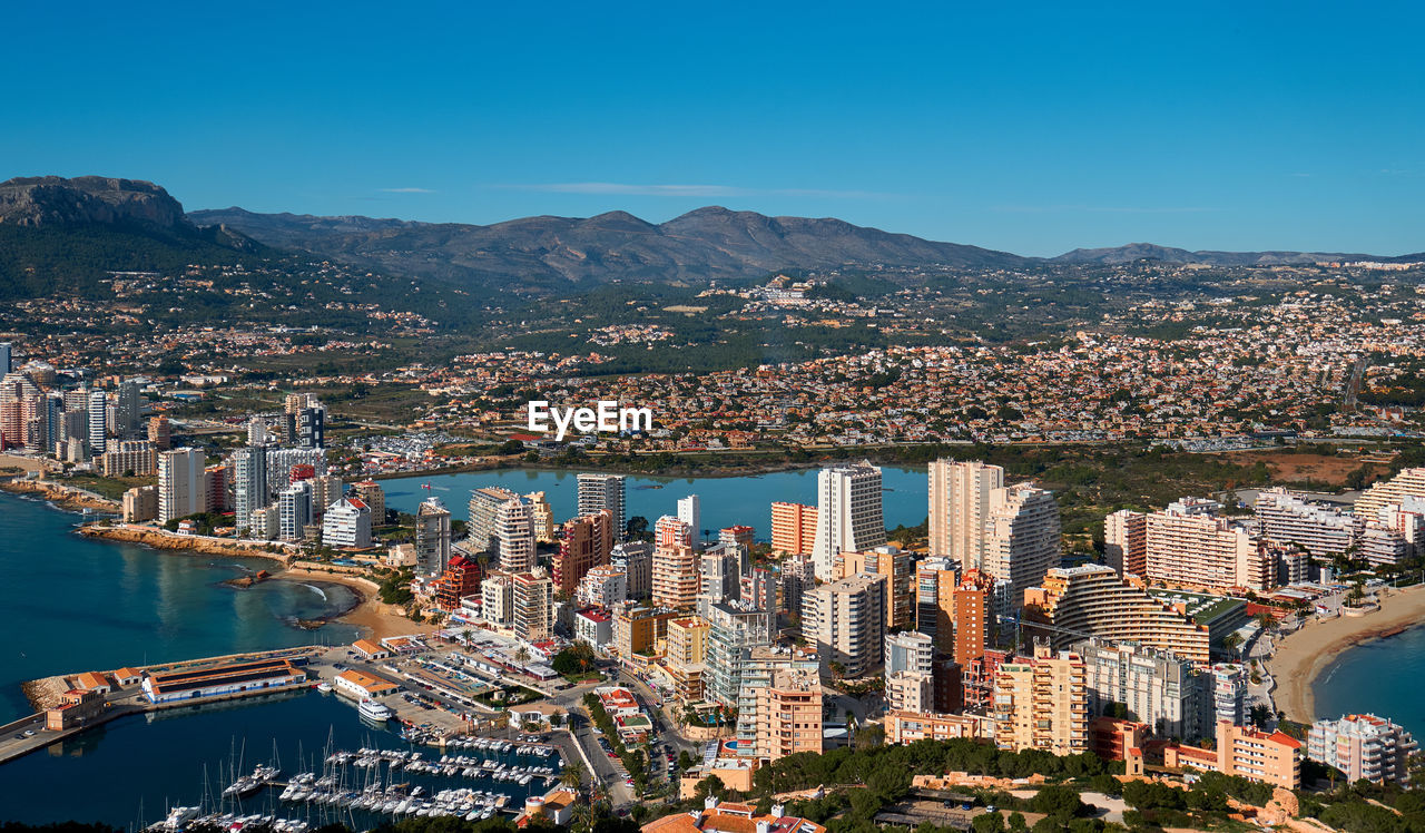 Aerial view of city and buildings against clear sky