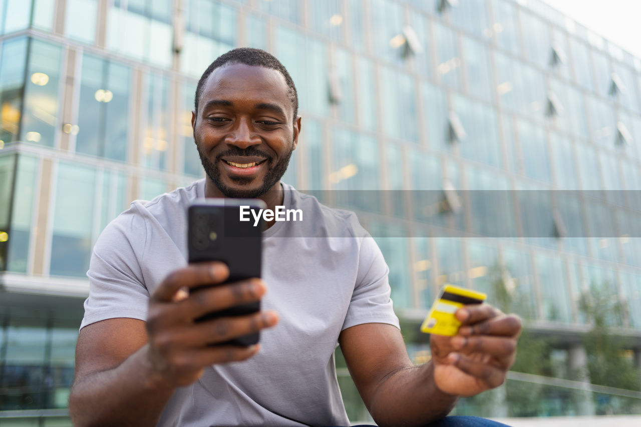 portrait of young man using mobile phone