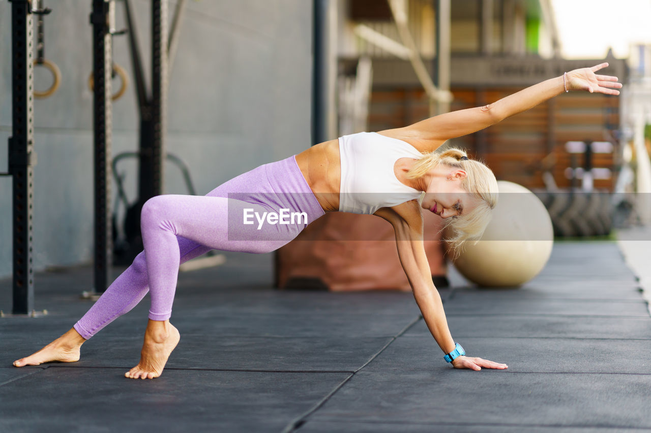 low section of woman exercising on hardwood floor