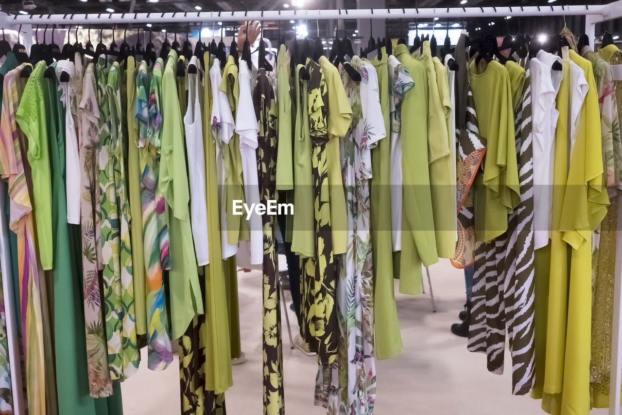 hanging, clothing, room, large group of objects, retail, variation, no people, in a row, coathanger, indoors, store, fashion, rack, business, abundance, shopping, multi colored, boutique, interior design, textile, clothes rack, side by side, closet