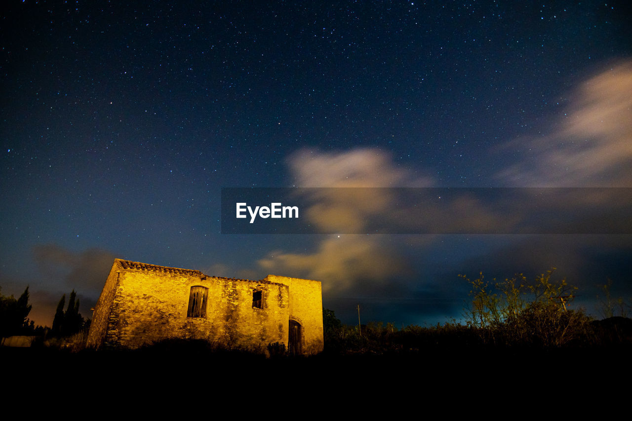 Low angle view of building against the sky at night