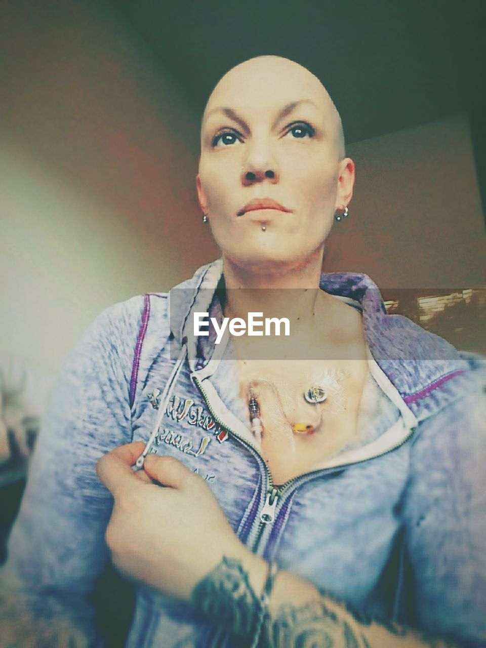 Low angle view of completely bald woman at home