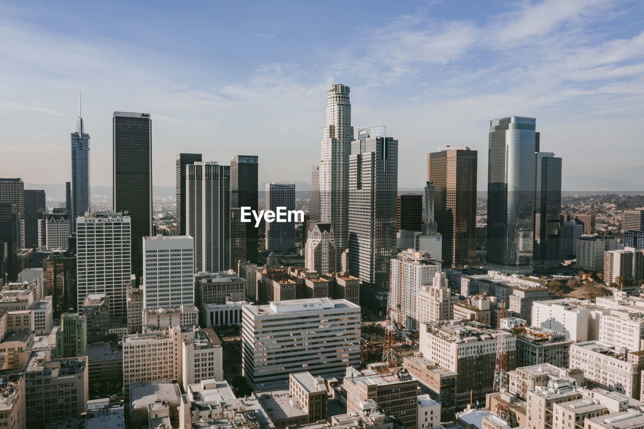 Aerial view of modern buildings in city against sky