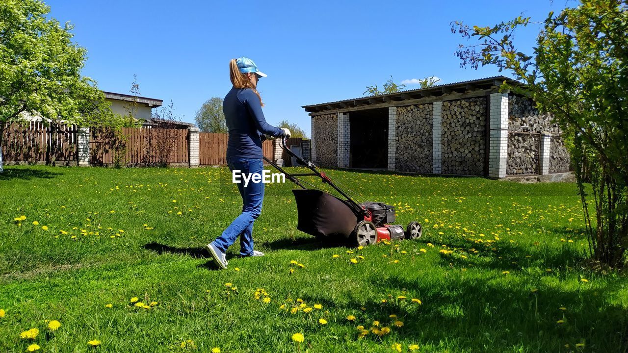 MAN STANDING BY PLANTS