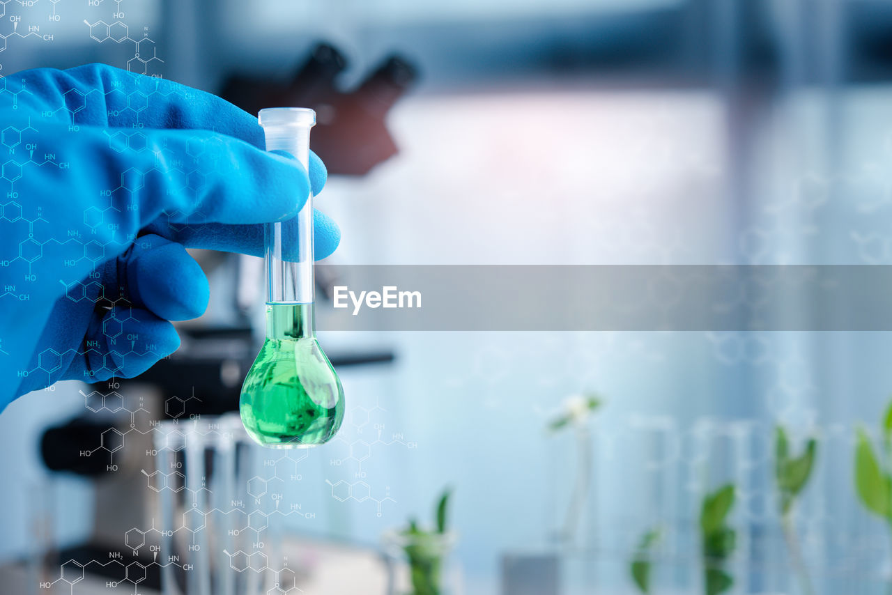 Cropped hand of scientist experimenting in laboratory