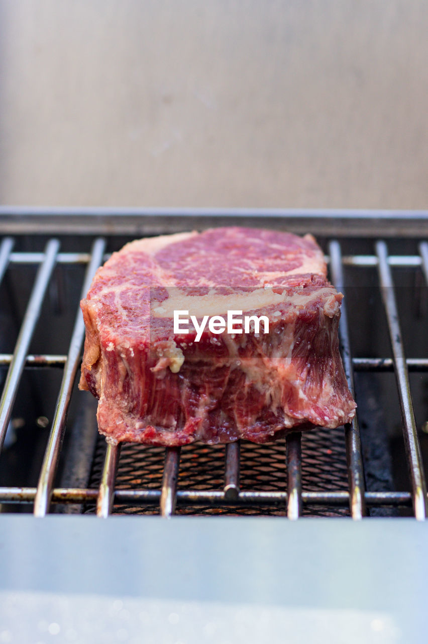 CLOSE-UP OF MEAT ON BARBECUE