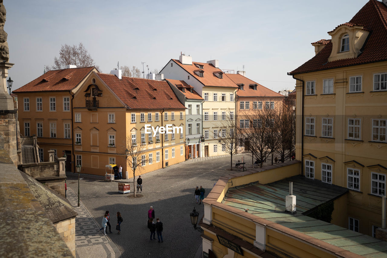 People walking on road amidst buildings in town