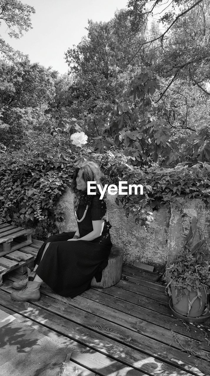 Thoughtful woman sitting on stool in balcony