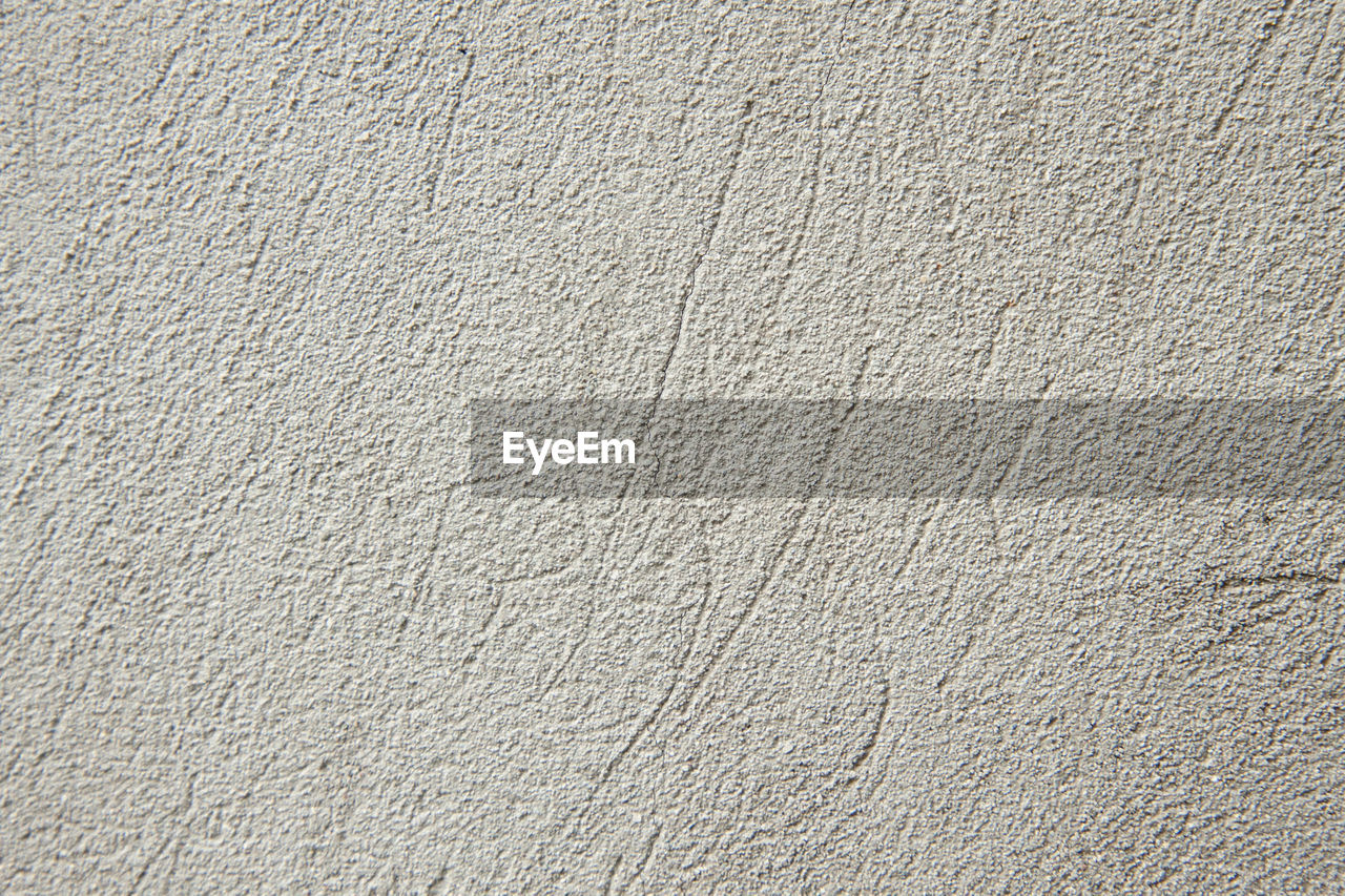 A concrete light-grey photo texture pattern. stone wall background. cement grunge pattern